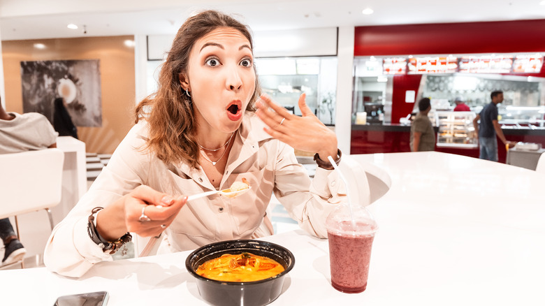 Woman eating spicy food 