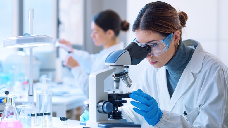 Woman looking through a microscope 