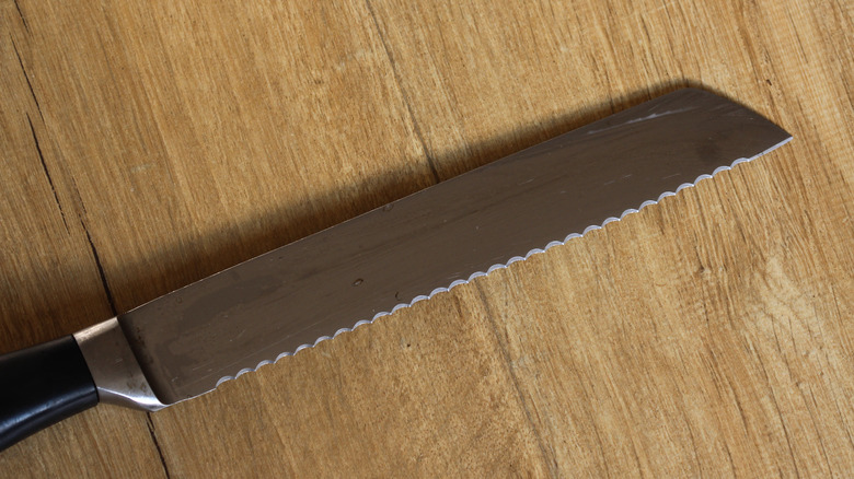 serrated knife on wooden table