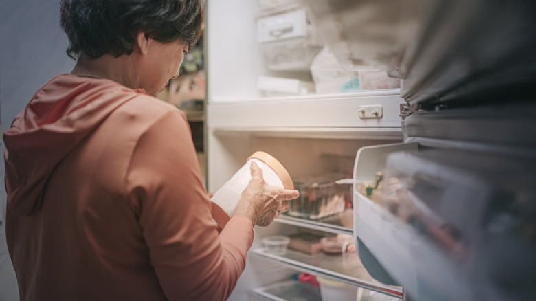 woman taking ice cream from freezer