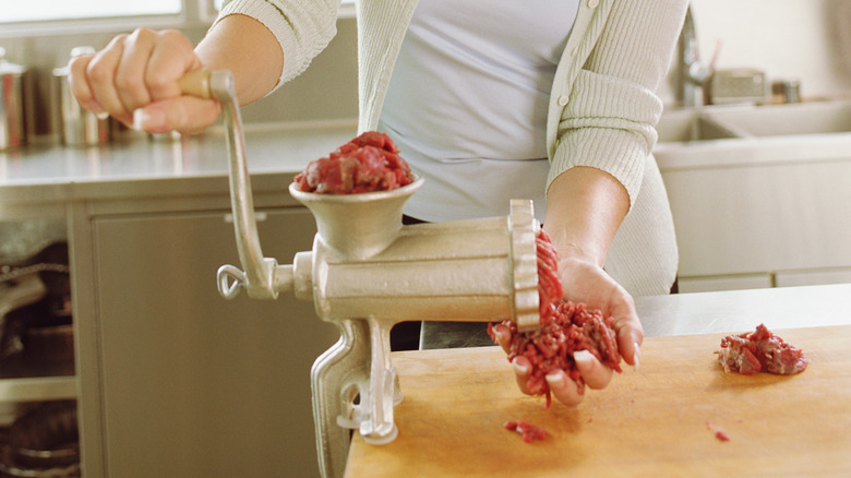 grinding meat with hand