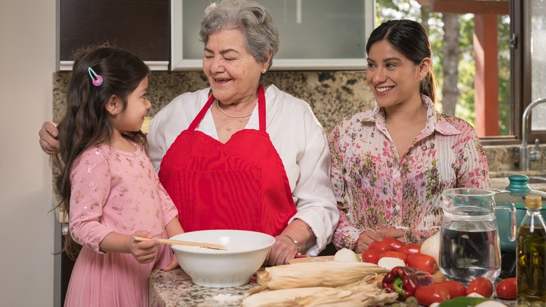 generations of Hispanic females in the kitchen making food