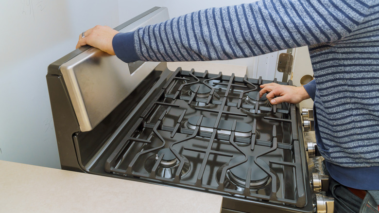 Person installing new oven range