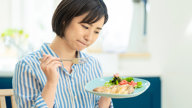 Woman unsure of food taste