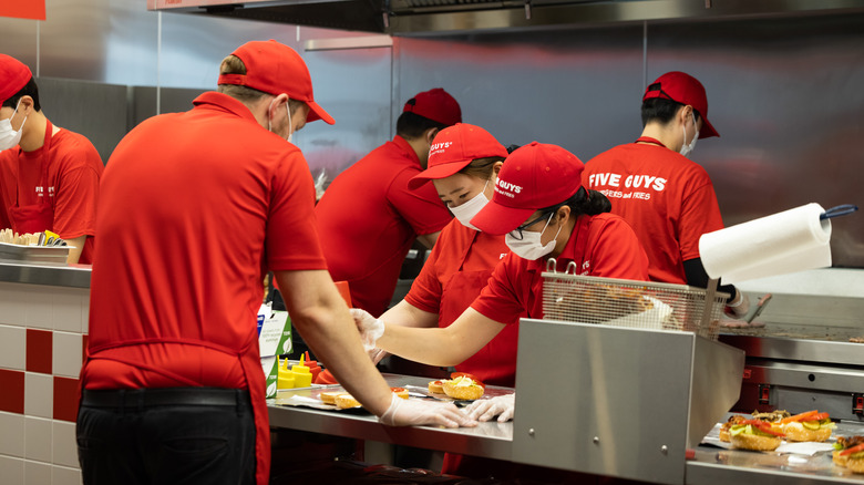 Five Guys employees working