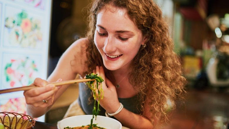 Woman using chopsticks