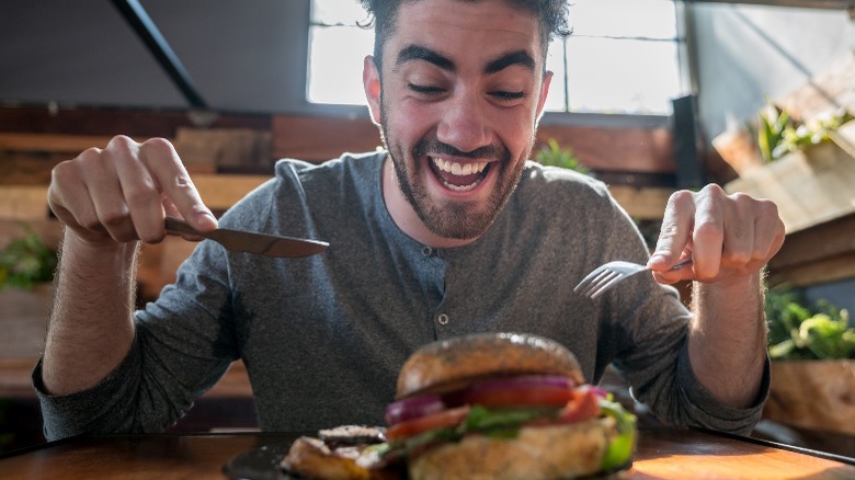 Eating burger fork and knife