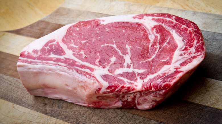 A raw ribeye steak