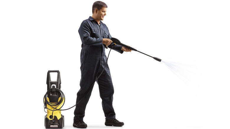 man with pressure washer