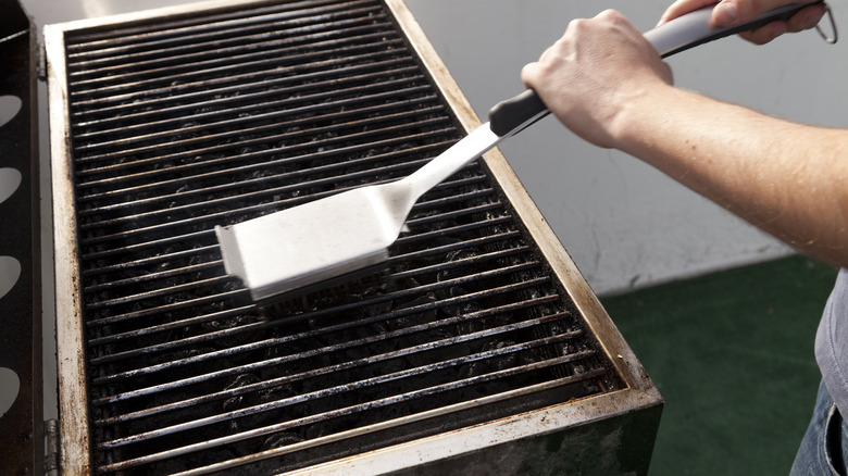 Cleaning a grill with brush