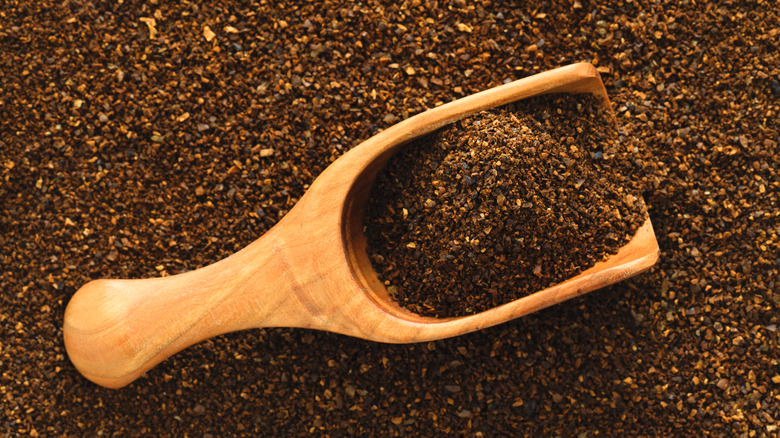 wooden scoop in ground coffee 