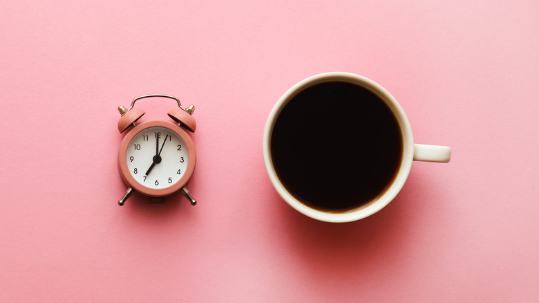 coffee with pink alarm clock