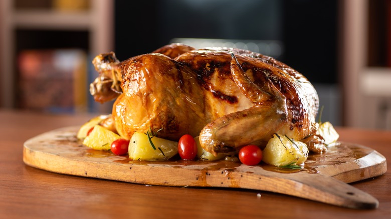 cooked chicken on wooden board