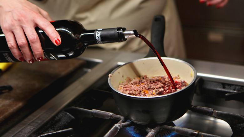 Pouring wine in beef sauce