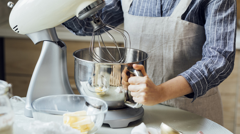 person using a stand mixer