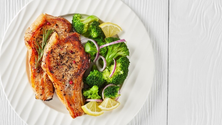 Two pork chops with broccoli