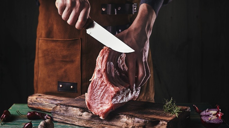 Person butchering pork loin