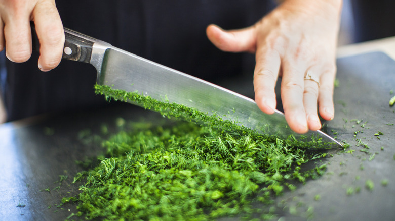 person chopping herbs