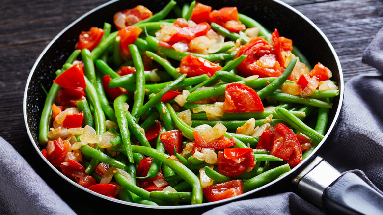 tomatoes and green beans in pan