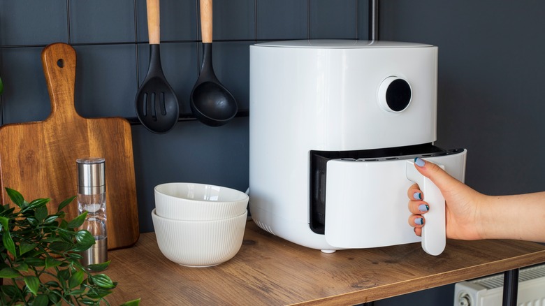 woman using air fryer