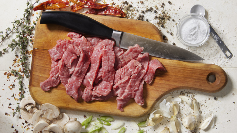 Sliced meat on cutting board