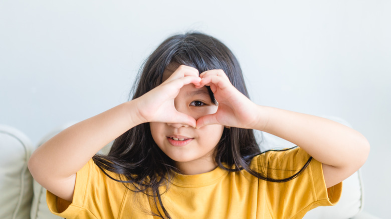 Girl with hands in heart shape