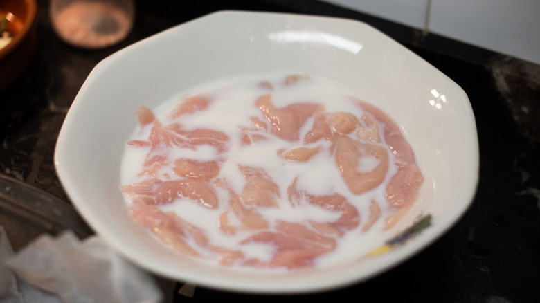 chicken being brined in milk