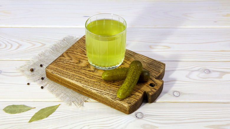 pickle juice in glass with pickles