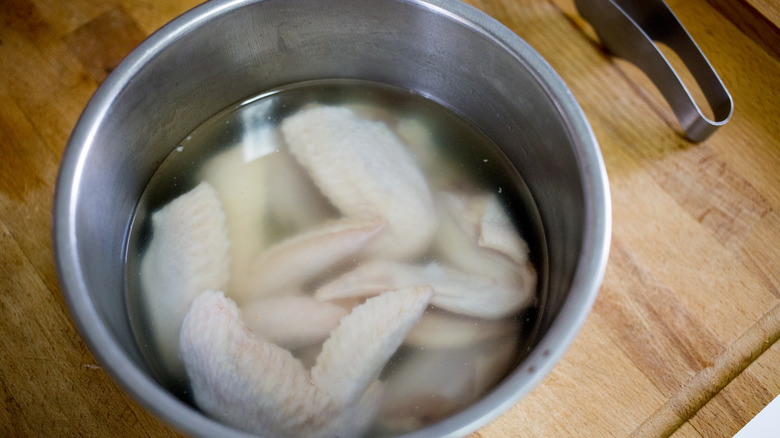 chicken wings soaking in brine