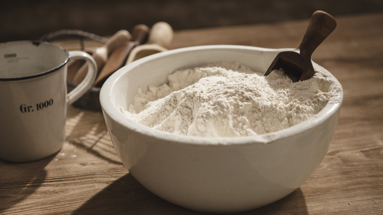 Bowl of white flour and flour scoop