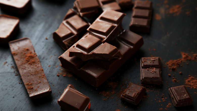 Pieces of chocolate on dark background