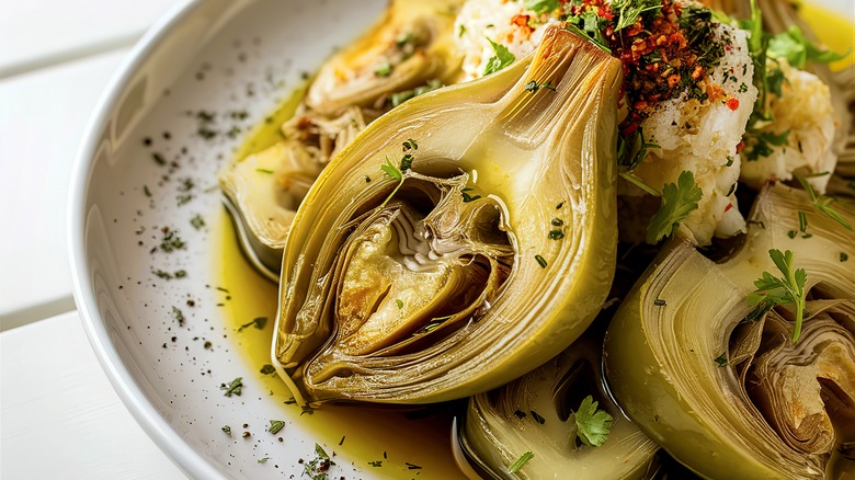 Plate of grilled, seasoned artichoke hearts.