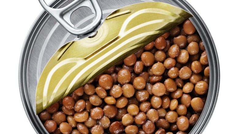 Half open can of brown lentils.