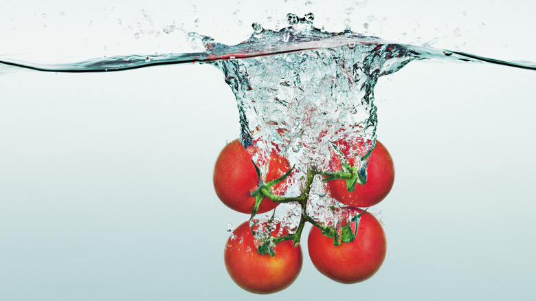 tomatoes splashing into water