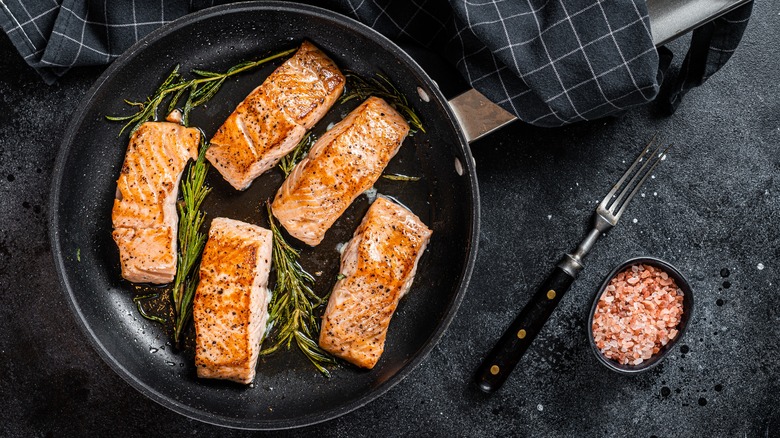 cooked salmon filets in a pan 