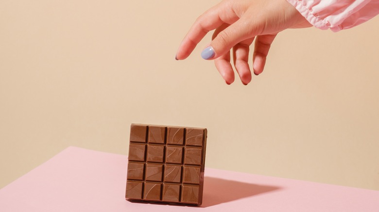 hand reaching for chocolate bar