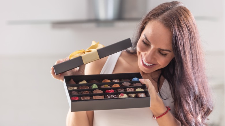 woman opening a chocolate box