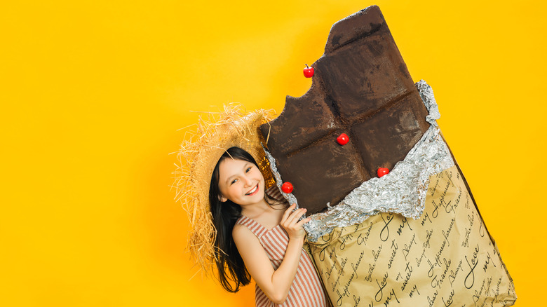 girl holding giant chocolate bar