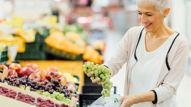 woman buying grapes