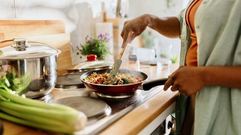 Person cooking on stove