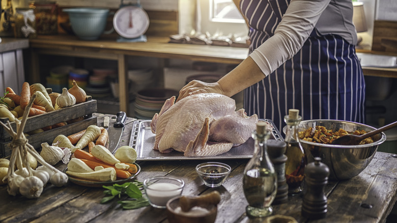 Raw turkey and food on table