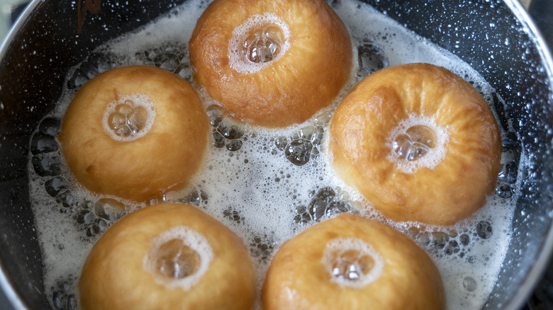 donuts frying in pan