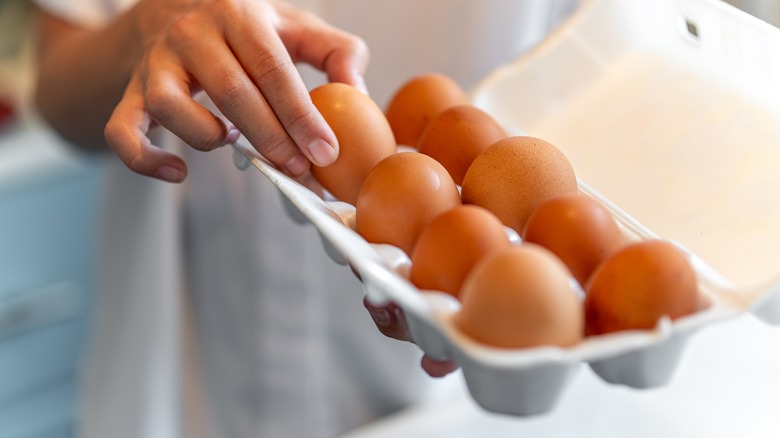 eggs being taken from carton