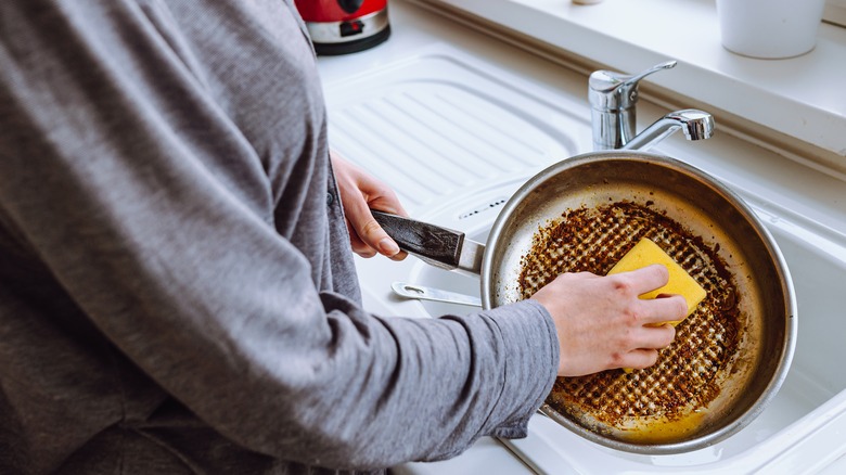 Person cleaning pan