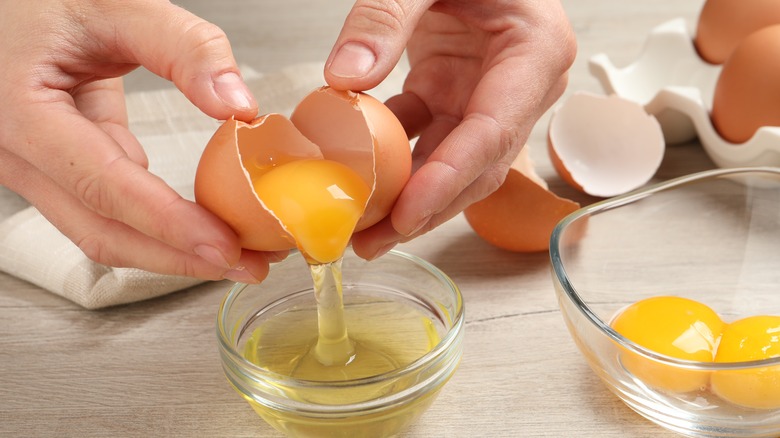 Hands cracking an egg open