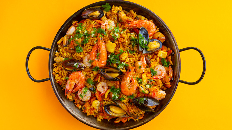 Traditional seafood paella in pot