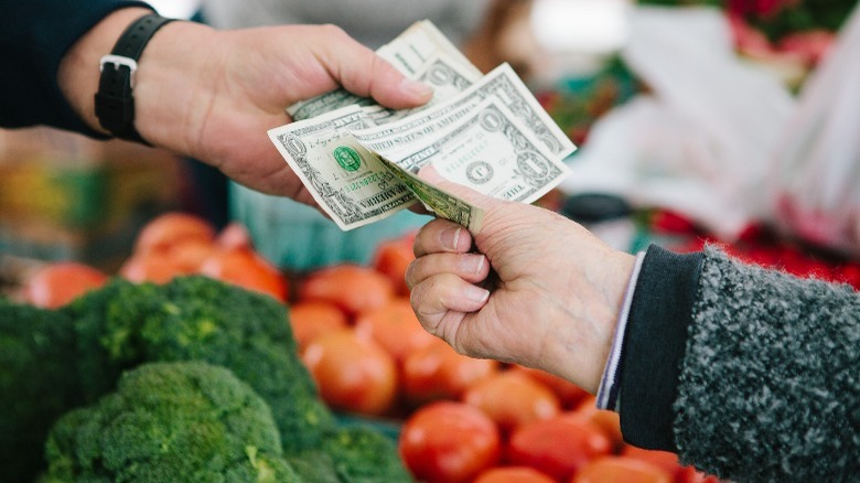 customer paying at farmers market