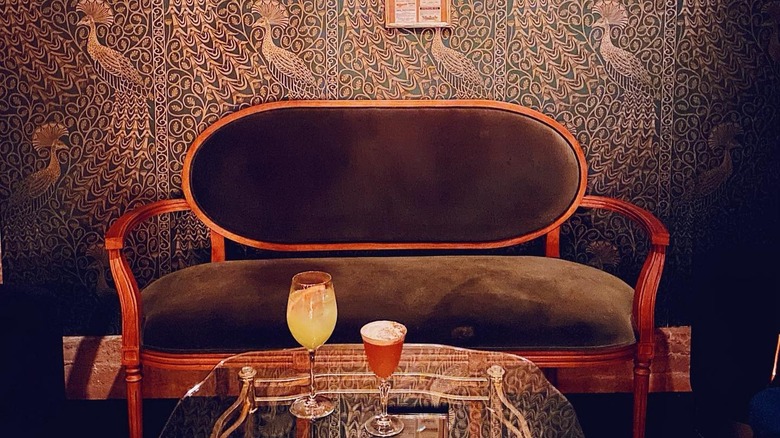 A chair with two cocktails in front