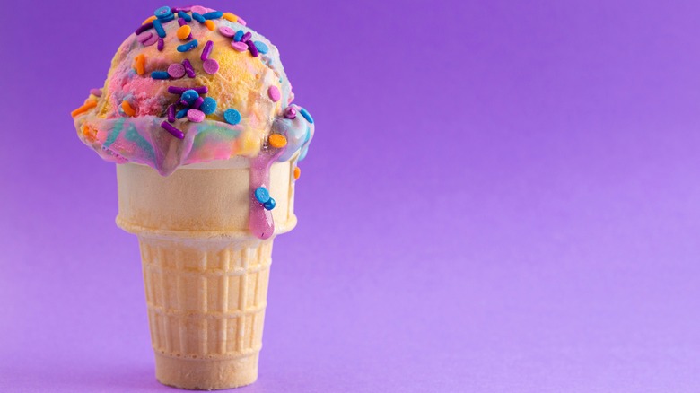 Scoop of colorful ice cream on cone