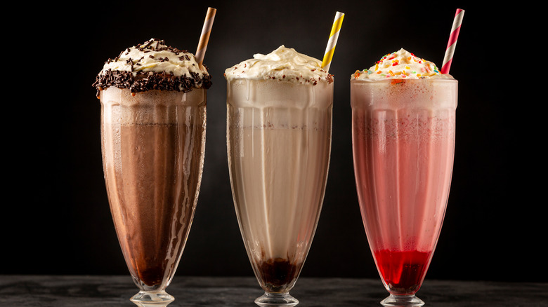 Three milkshakes with straws